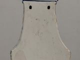 a white vase with a bird on top of it