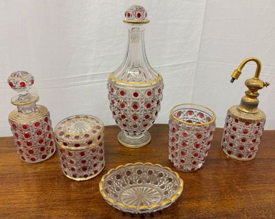 several pieces of glass on a wooden table with a gold faucet