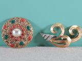pair of vintage brooches and earrings on a table