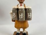 a figurine of a woman holding three barrels