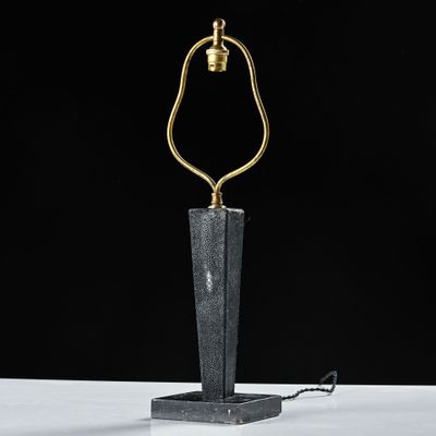 a black marble table lamp with a gold metal base