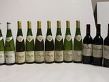 several bottles of wine are lined up in a row on a table