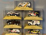 six toy cars in a display case on a table