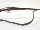 un vieux fusil muni d'un porte-verre fixé sur le côté