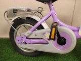 a small purple bike with a basket on the back of it