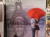 a picture of a couple kissing under a red umbrella