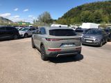 a lot of cars parked in a lot with mountains in the background