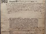 an old document with writing on it sitting on top of a table