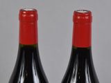 two bottles of wine that are sitting on a table