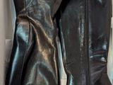 black leather boots in a box on a white surface