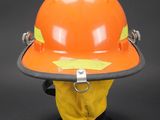 an orange hard hat with a safety tag attached to it ' s side