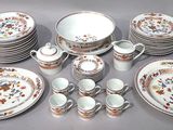 many plates and cups and saucers on the table
