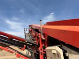 a red crane that is sitting on the side of the road