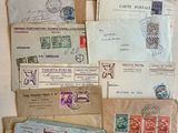 a lot of old envelopes and stamps on the table