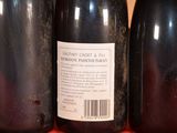 three bottles of wine sitting on a table