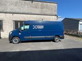 a blue van that is parked in front of a building