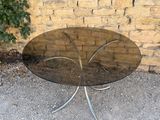 a glass table with a metal base and a glass top