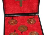 an image of a box with four medals in it on a white background