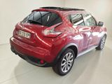 the rear end of a red nissan juke parked in a garage