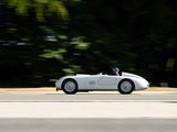 a white car driving down the road with trees in the background