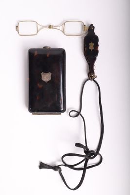 a cell phone and a pair of glasses on a white surface