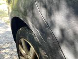 a black car that has a hole in the side of it
