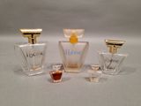 three different perfume bottles sitting next to each other on a table