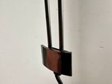 a metal pole that has a wooden handle on top of it