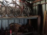 many bikes that are sitting on a shelf in a shed
