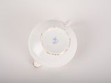 an overhead view of a white plate with a blue flower on it