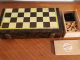 a wooden box with a checker board and a box of nuts