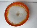 an orange bowl with a white substance in it on a table