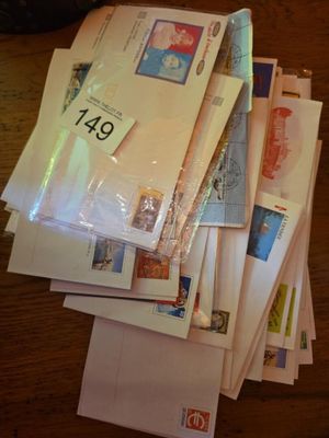 a pile of mail sitting on top of a wooden table