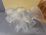 a glass sculpture of a bird sitting on a table