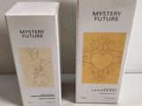 two boxes of mystery future perfume sitting on a table