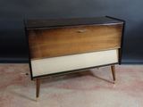 a brown and white chest of drawers sitting on top of a carpeted floor