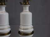 pair of white and gold porcelain lamps with brass trims
