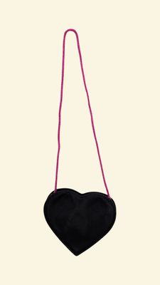 black heart shaped purse hanging from a pink string