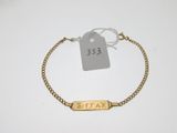 Gros plan sur un bracelet en or portant une étiquette