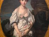 portrait of a woman in a white dress holding a basket of flowers
