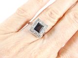an image of a woman ' s hand with a ring on it