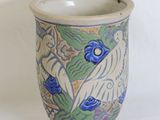 a blue and white vase with a bird on it