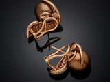 two pairs of gold earrings with diamonds on a black background