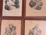 four framed pictures of a man and a woman holding a baby