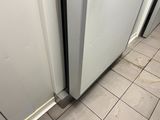 a white refrigerator and a white refrigerator freezer in a kitchen