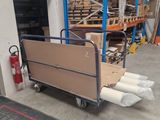 a cart that has a lot of boxes on it in a warehouse