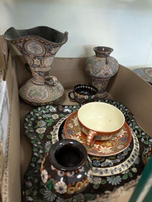 many vases and plates in a box on the table
