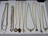 a lot of necklaces that are sitting on a table