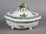 a white bowl with a green and yellow decoration on it