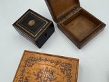 three small wooden boxes on a white table
